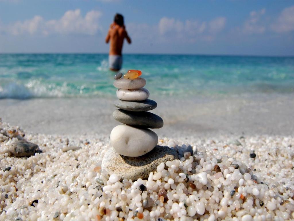 a stack of rocks sitting on a beach at Sinis Holiday House in Oristano