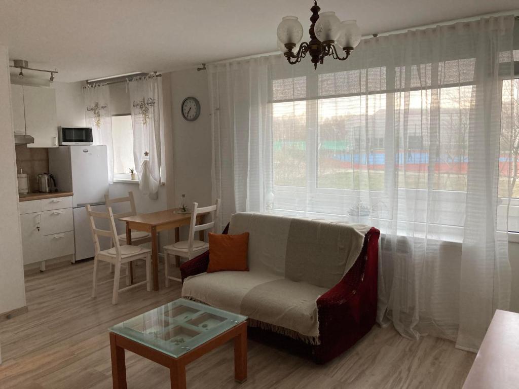 a living room with a couch and a table at Baltic Sea Beach Apartment in Liepāja