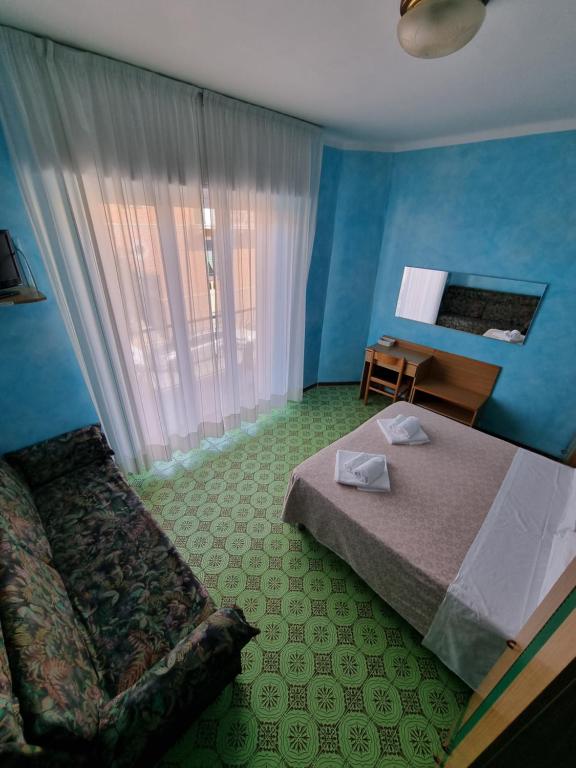 Postel nebo postele na pokoji v ubytování Albergo Stella Di Mare