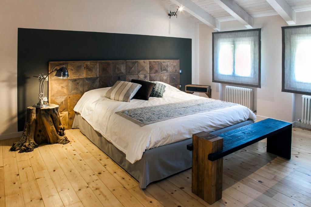 a bedroom with a large bed with a wooden headboard at El pavejo in Brendola