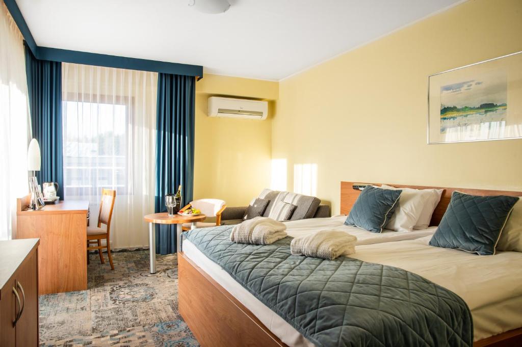 Posteľ alebo postele v izbe v ubytovaní Hotel Mrągowo Resort&Spa