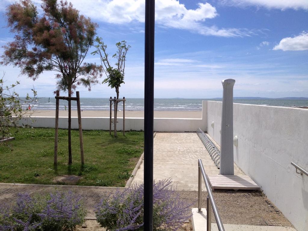 a view of the beach from the balcony of a house at Les plages du Grand Vallen - Résidence Château Leenhardt in Le Grau-du-Roi