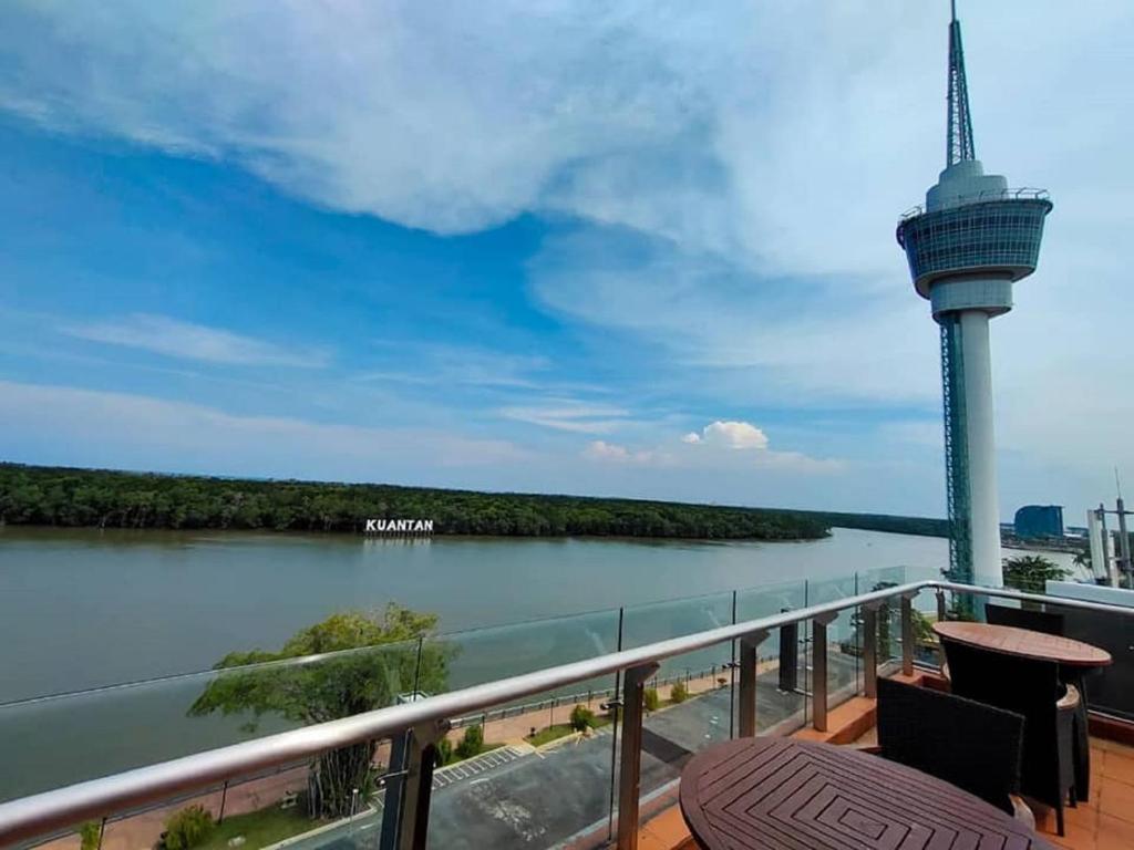 a balcony with a view of a river and a tower at Hotel Sentral Kuantan @ Riverview City Centre in Kuantan