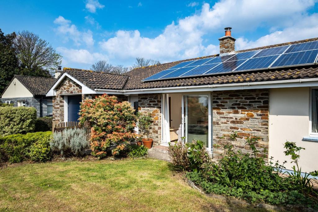 a house with solar panels on the roof at Highlands in Port Isaac