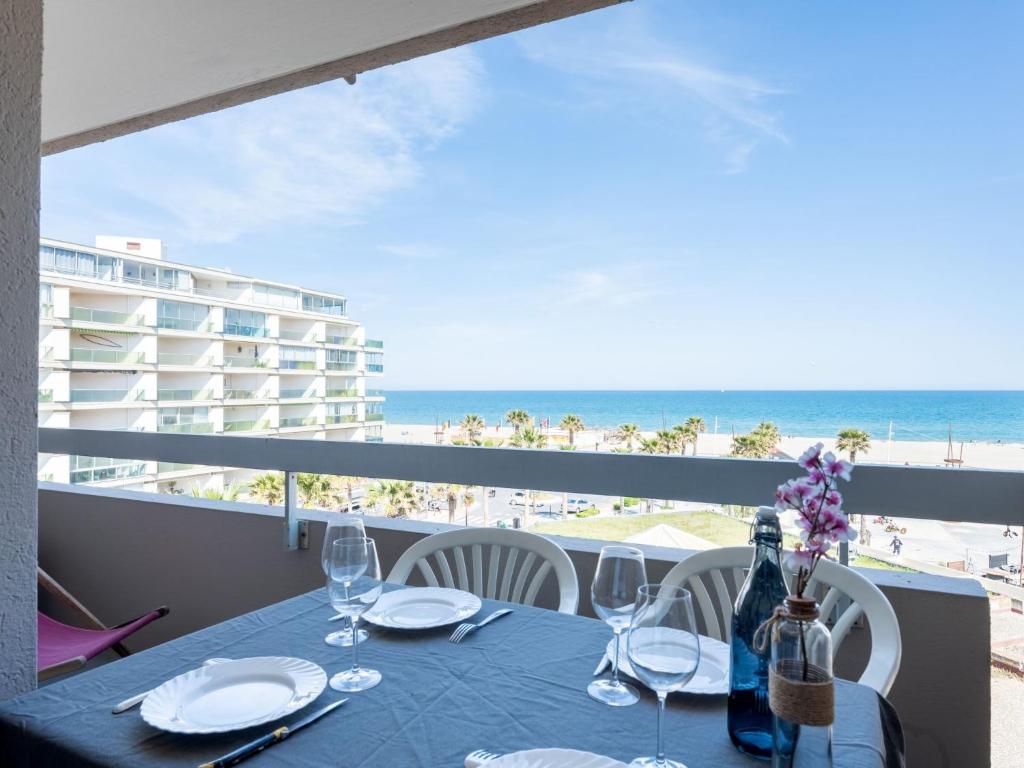 a dining table with a view of the beach at Apartment Ipanema Sud-6 by Interhome in Canet-en-Roussillon