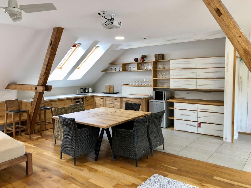 a kitchen with a wooden table and chairs at Statek Samsara in Blansko