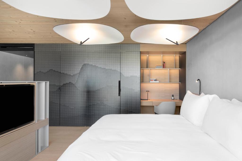 Postel nebo postele na pokoji v ubytování Hôtel des Horlogers