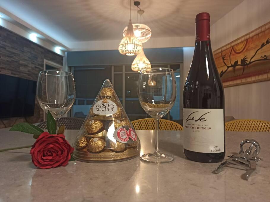 Una botella de vino y dos copas en una mesa en Sea&Surf Deluxe Olga, en H̱adera