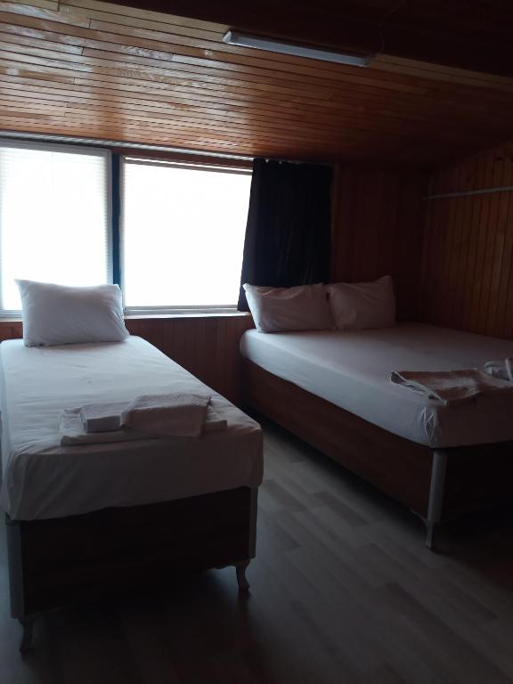 Postel nebo postele na pokoji v ubytování GÜVEN HOTEL