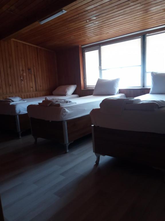 Postel nebo postele na pokoji v ubytování GÜVEN HOTEL