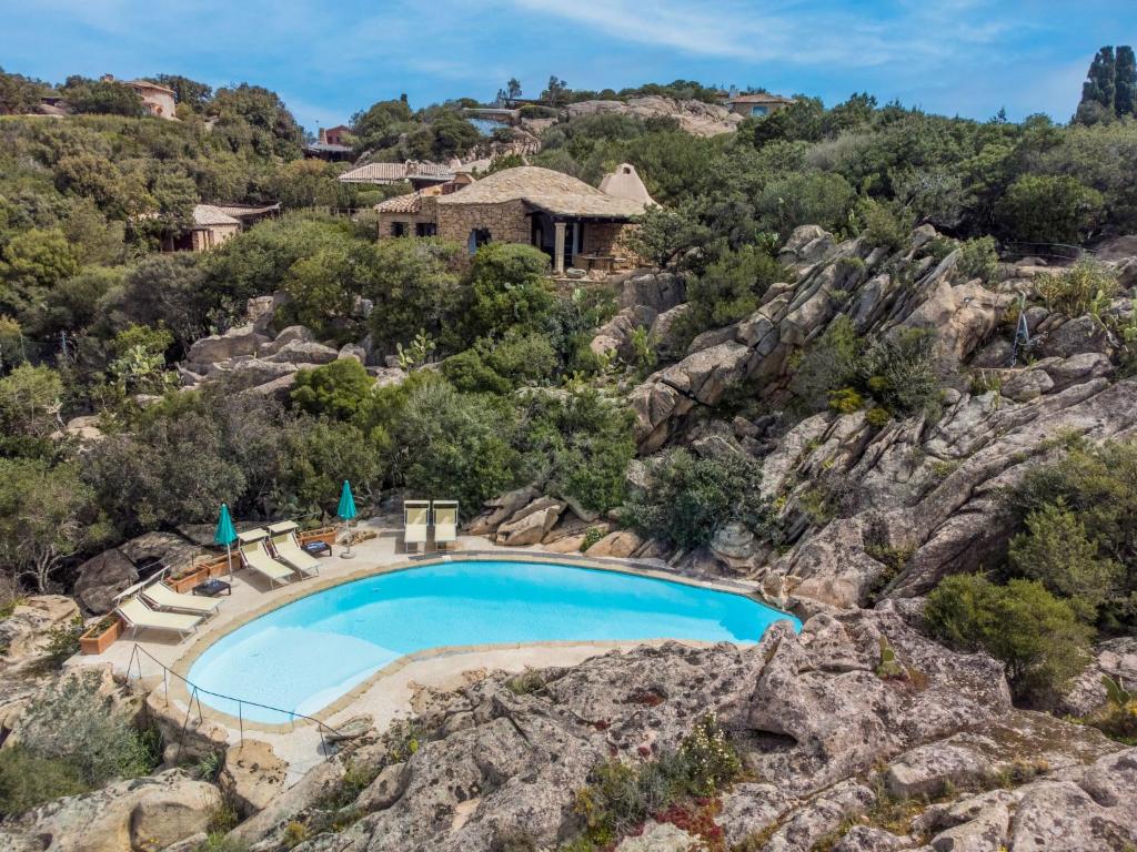 an aerial view of a swimming pool on a rocky mountain at Holiday Home Roccia di Volpe by Interhome in Porto Cervo