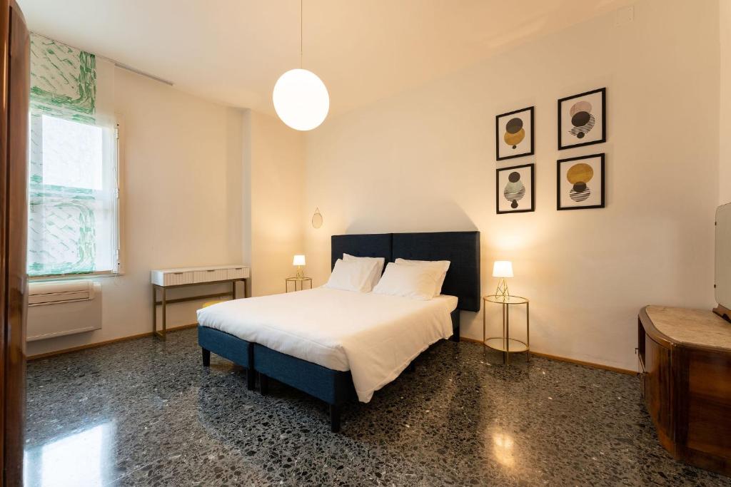 a bedroom with a large bed and a window at Por Santa Maria Apartment in Florence