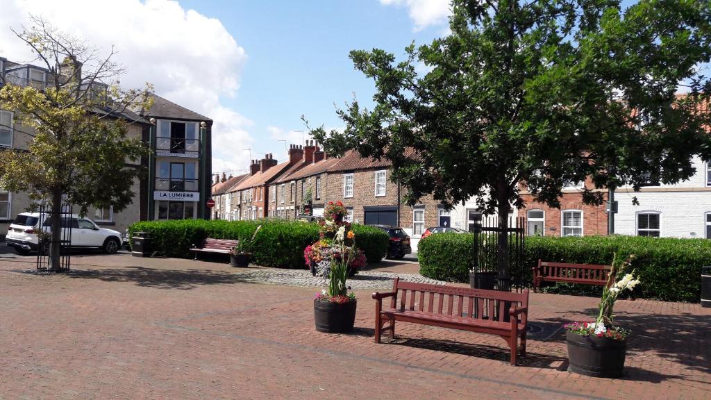 a park with benches and trees and buildings at 37 Trinity Lane in Beverley