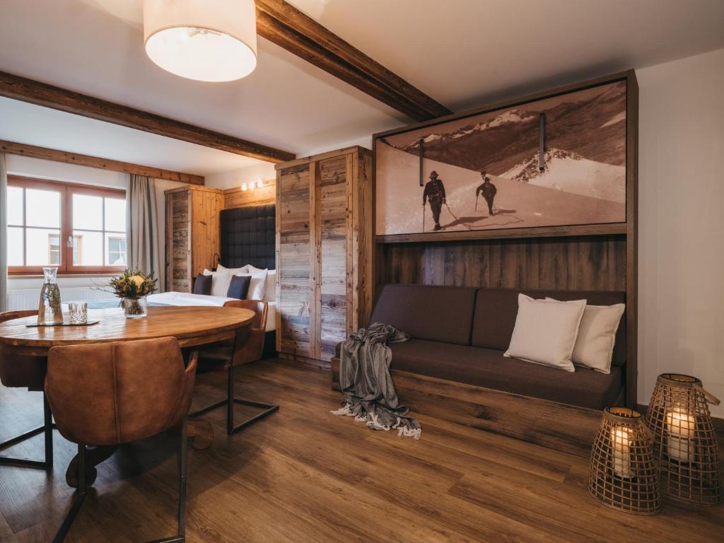 a living room with a couch and a table at VAYA Kaprun inklusive Zell am See Kaprun Sommer Karte in Kaprun