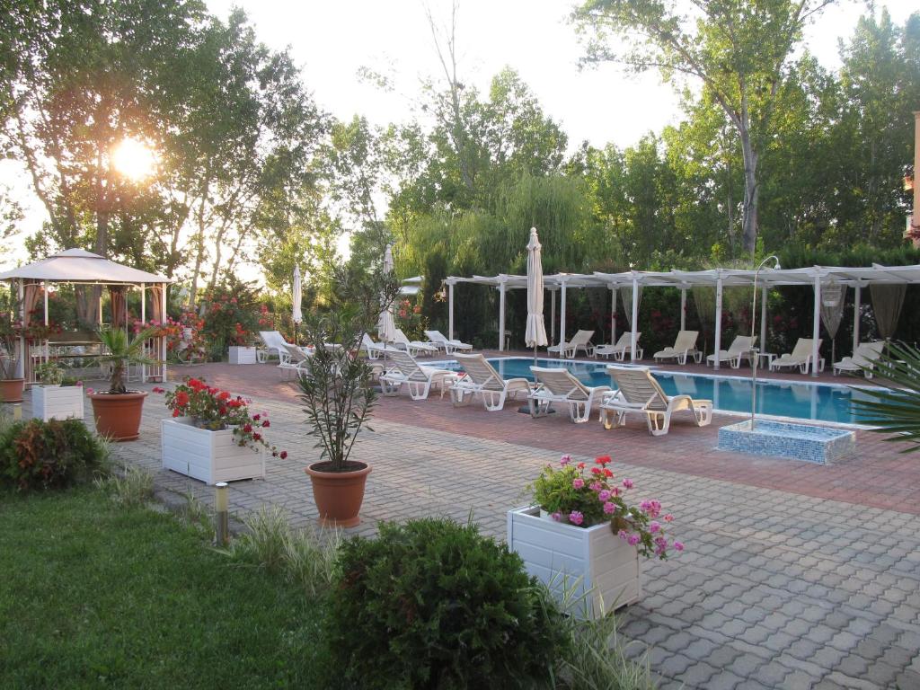 a patio with chairs and a swimming pool with at Apartments and studios in Cote d’Azure in Sunny Beach