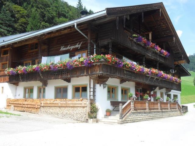 a building with flowers on the front of it at Hausbergerhof Gästehaus Ainberger in Brixlegg