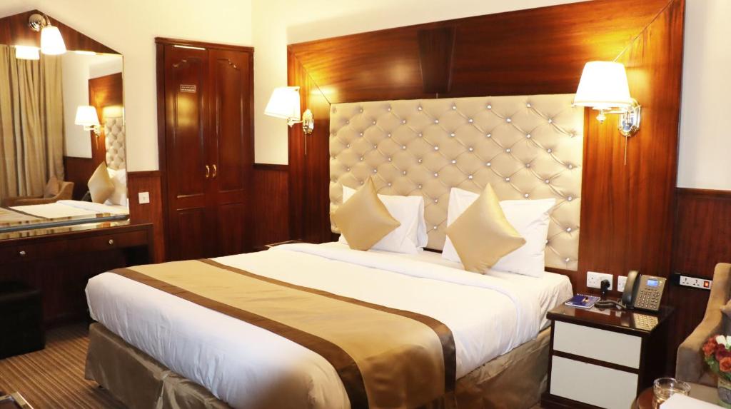 a hotel room with a large bed and a mirror at Gulf Inn Hotel Deira Formerly City Star Hotel in Dubai