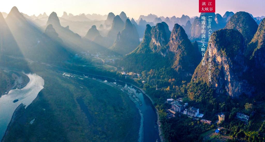 an aerial view of a river and mountains at Yangshuo Mountain River Ballad Hotel - Free Yangshuo Train Station Pick Up and Drop Off in Yangshuo