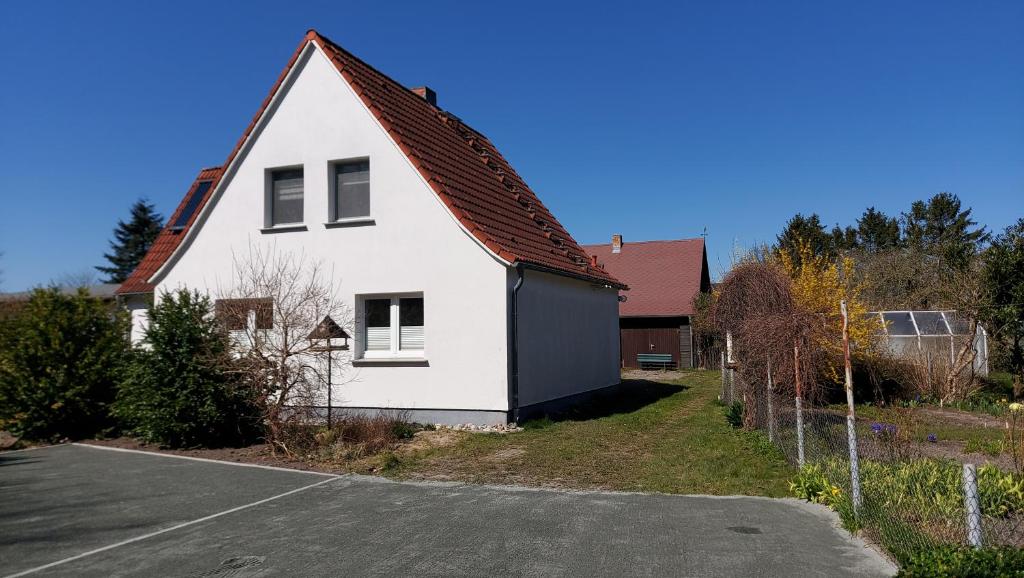 a white house with a red roof at Ferienhaus Imke Breege in Breege