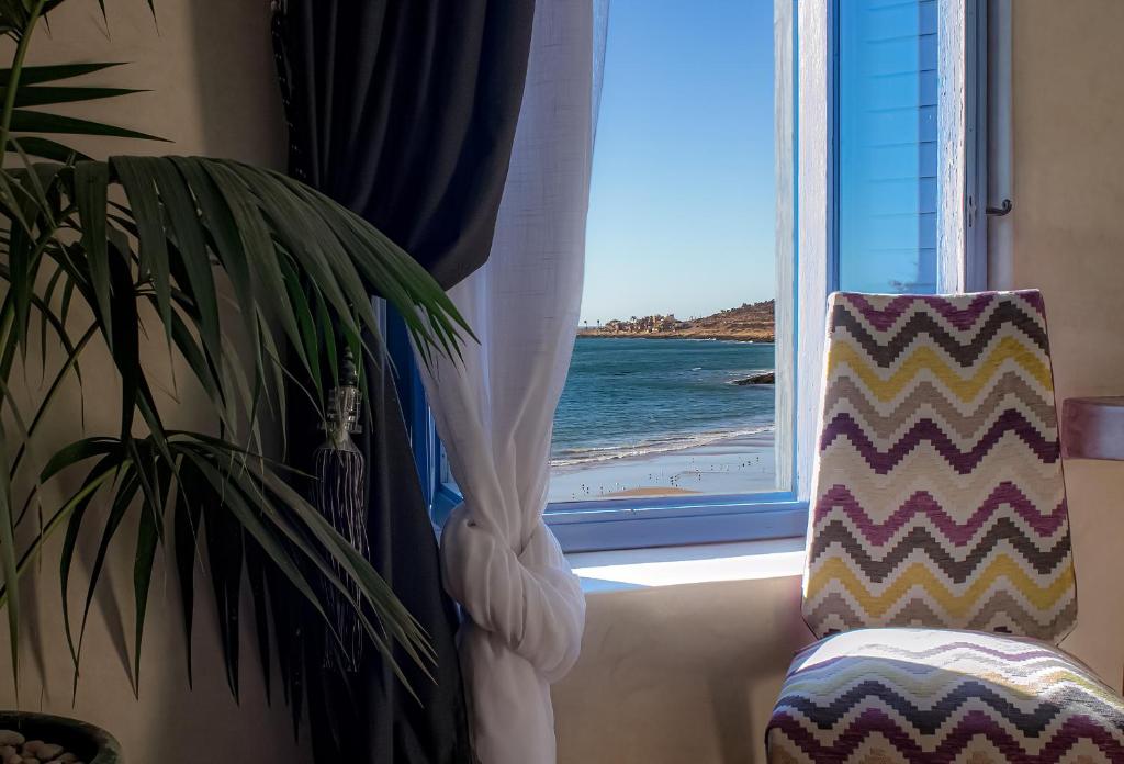 a window with a view of the beach at TEDDY PIRATE - Coliving in Taghazout