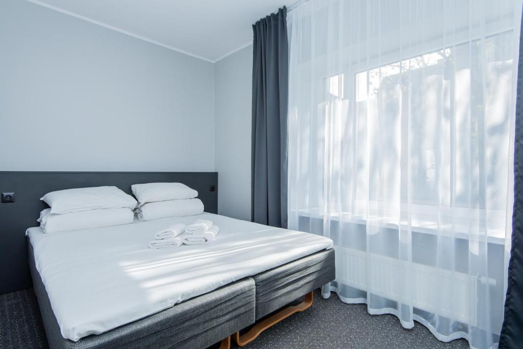 Postel nebo postele na pokoji v ubytování Palanga Centrum