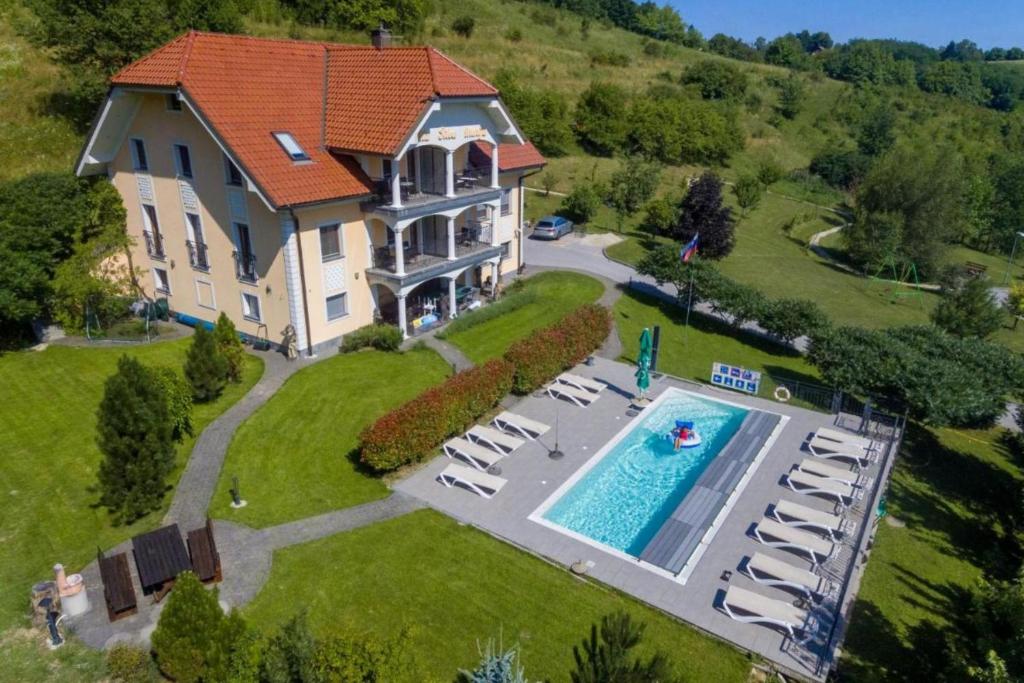 an aerial view of a large house with a swimming pool at Pool Villa Silva Marija Apartments in Pišece