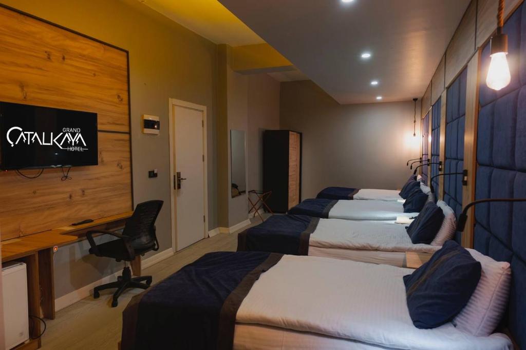 A bed or beds in a room at Grand Catalkaya Hotel