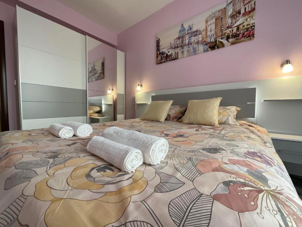 a bedroom with a large bed with pillows on it at Nataly Homes in Veliko Tŭrnovo
