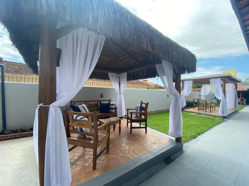 a patio with a umbrella and chairs and a table at Pousada Recanto Forte in Florianópolis