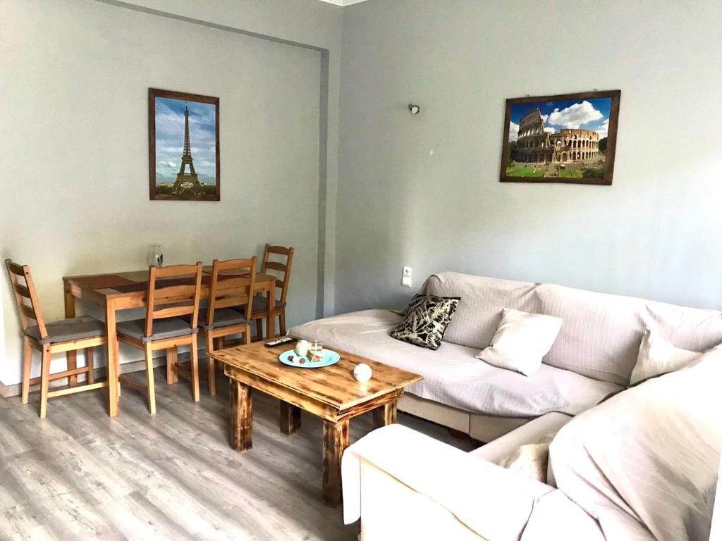 a living room with a couch and a table at Captain Michalis house in Parga