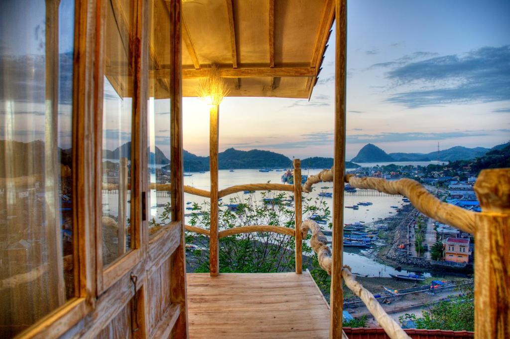 a room with a view of a river and a city at Selini Hills in Labuan Bajo