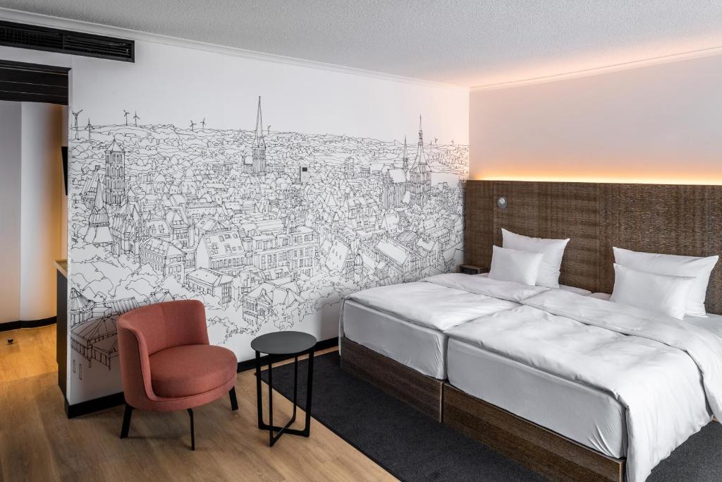 Tempat tidur dalam kamar di Pentahotel Rostock