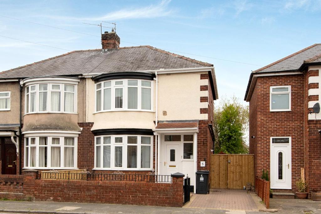 a red brick house with a white door at Teal Road in Darlington