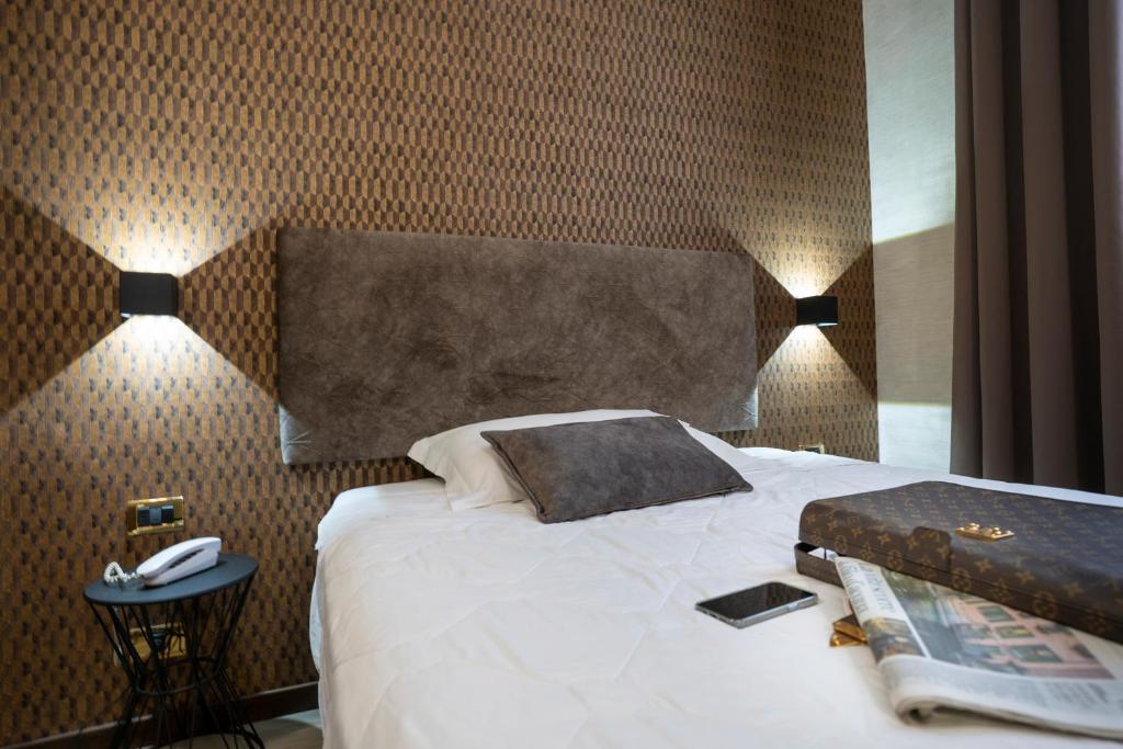 Postel nebo postele na pokoji v ubytování Hotel Astoria