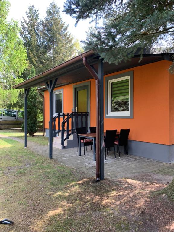 a house with a table and chairs on a patio at Pension Lausa in Lausa