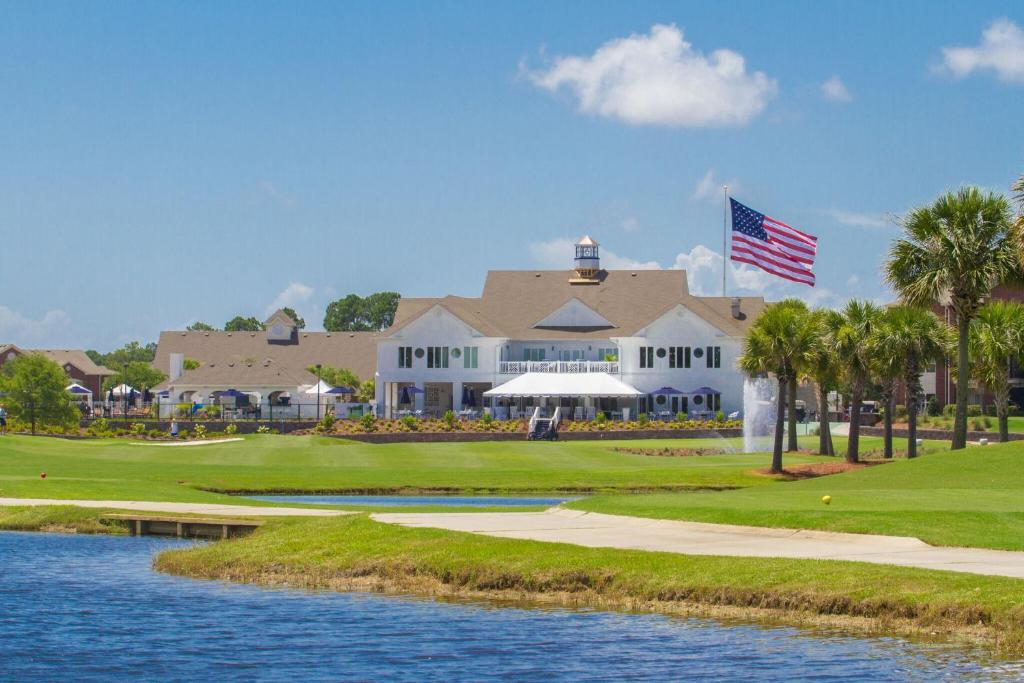 a view of the golf course at the resort with a flag at One Club Gulf Shores in Gulf Shores