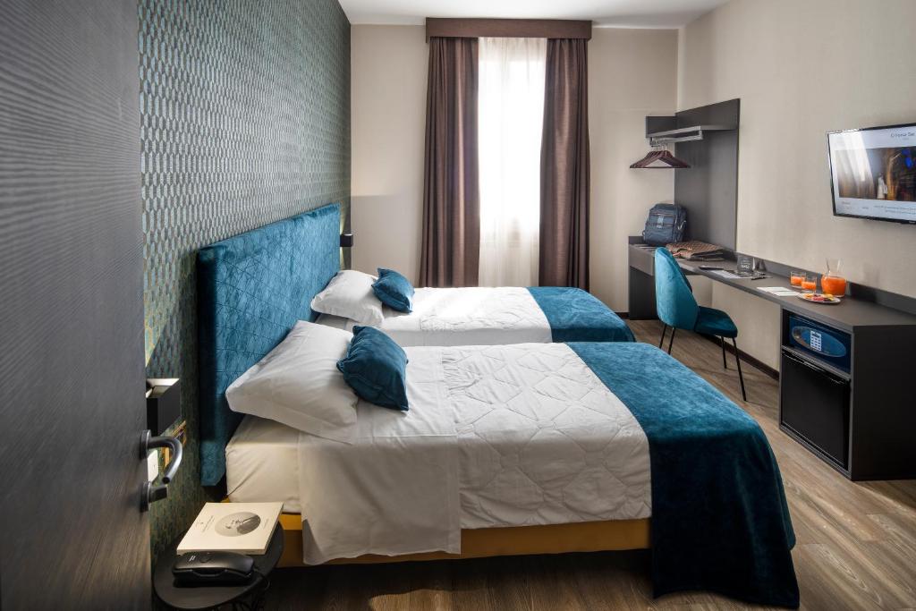 Postel nebo postele na pokoji v ubytování Hotel Astoria