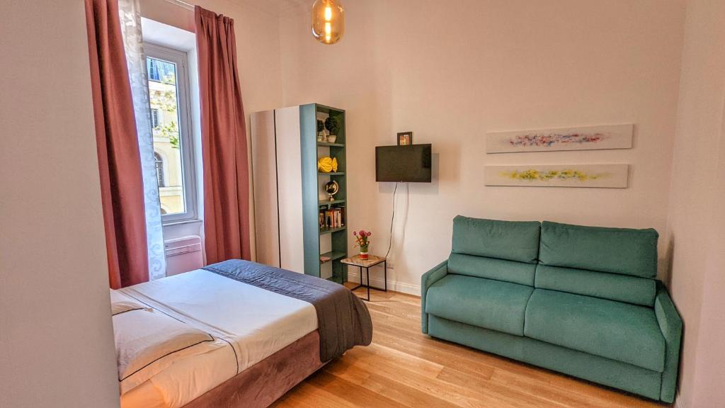 a bedroom with a bed and a green chair at Beatrix House in Rome