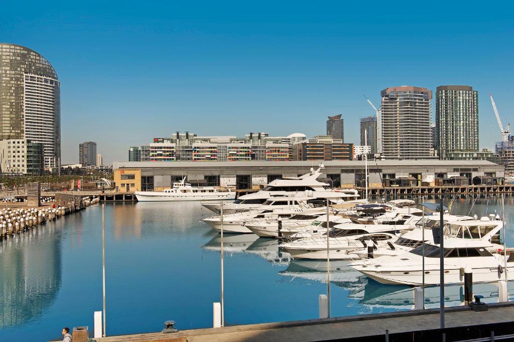 a bunch of boats are docked in a harbor at Docklands Private Collection - NEWQUAY in Melbourne