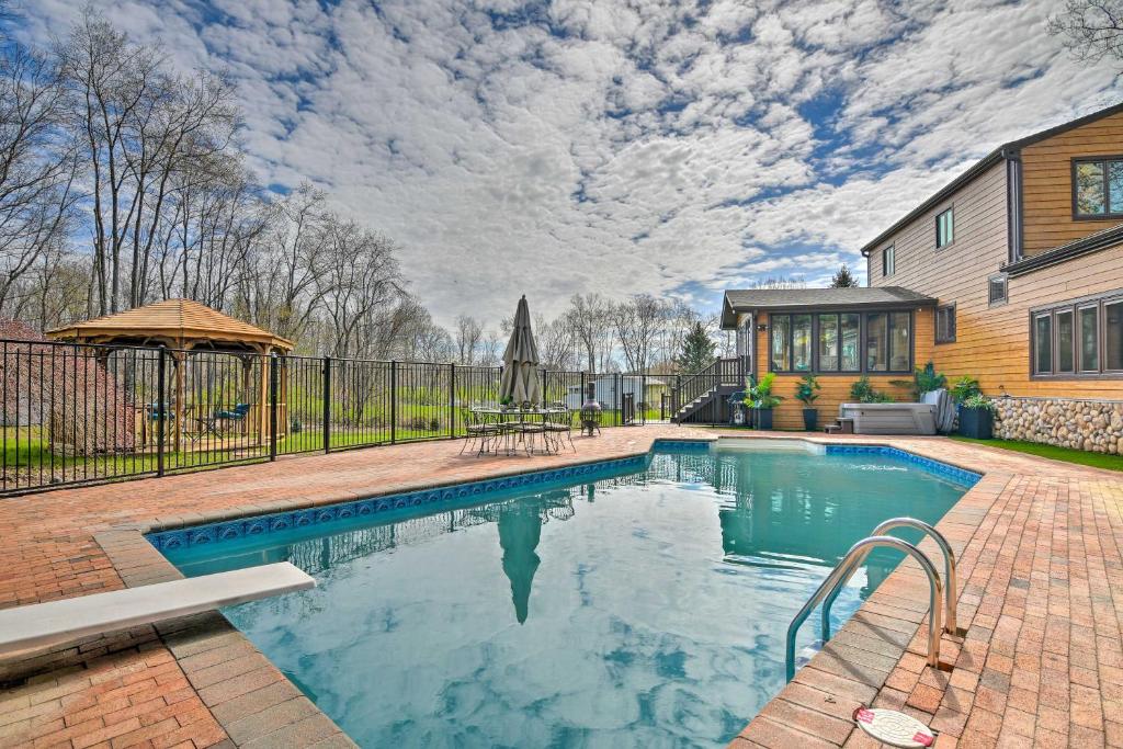 a swimming pool in the backyard of a home at Lovely Highland Home with Pool and Hot Tub! in Highland