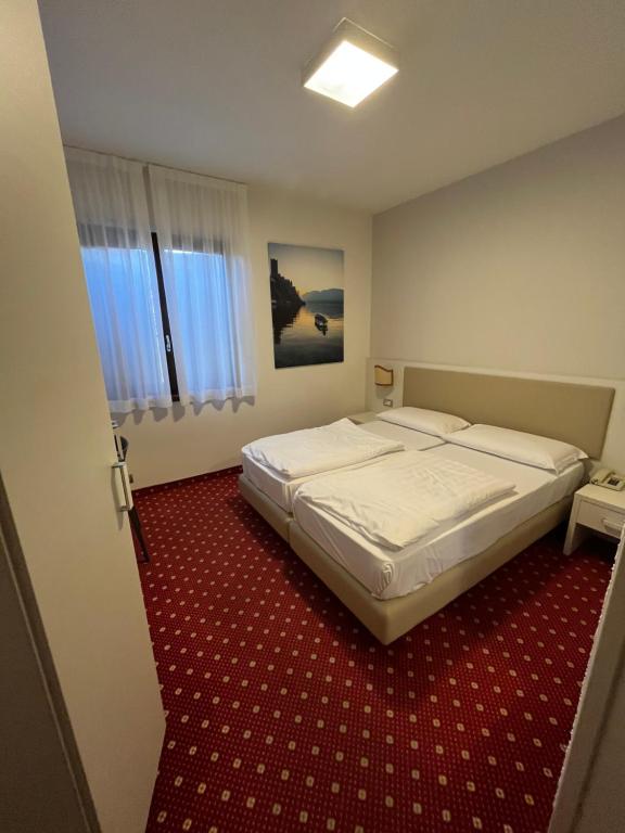 Postel nebo postele na pokoji v ubytování Hotel Villa Nadia