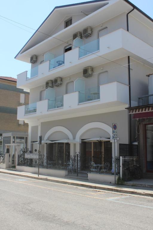 un bâtiment blanc sur le côté d'une rue dans l'établissement Hotel Solaris, à Giulianova