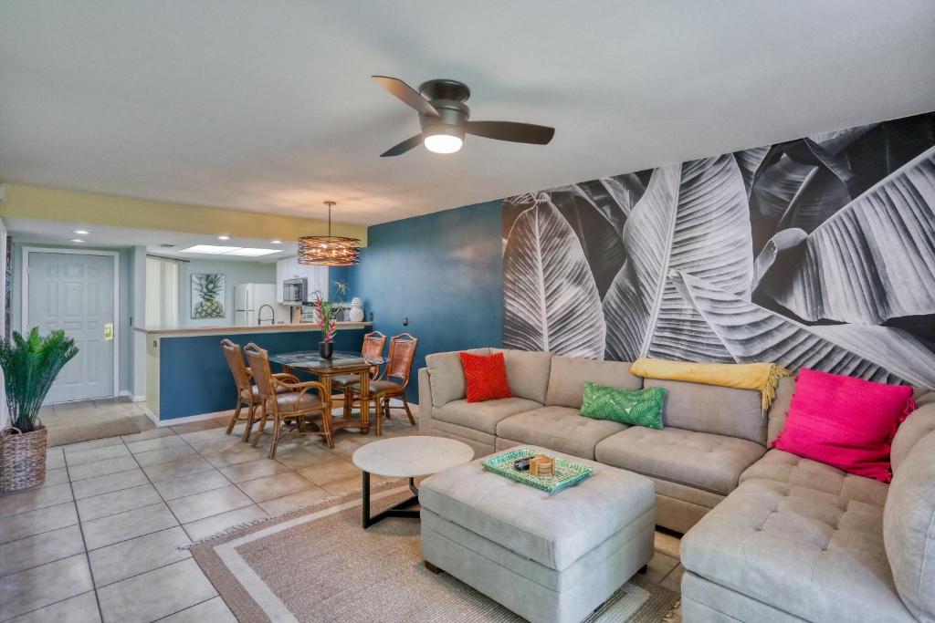 a living room with a couch and a table at Modern Palm Paradise in Bradenton