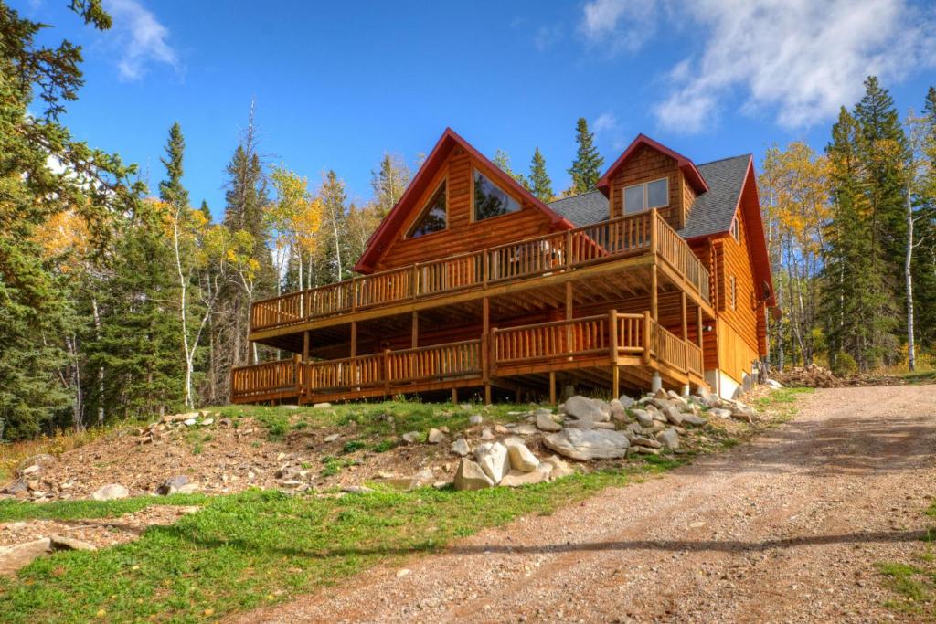 a large wooden house on a hill in the woods at Black Diamond Lodge in Lead