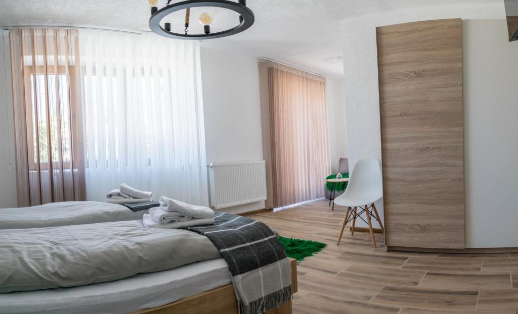 a bedroom with two beds and a chandelier at Casa al Tagas in Kruševo