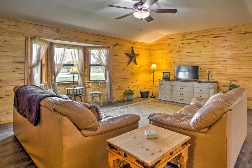 a living room with two leather couches and a table at Emory Escape with Pond Access Less Than 13 Mi to Lake! in Emory