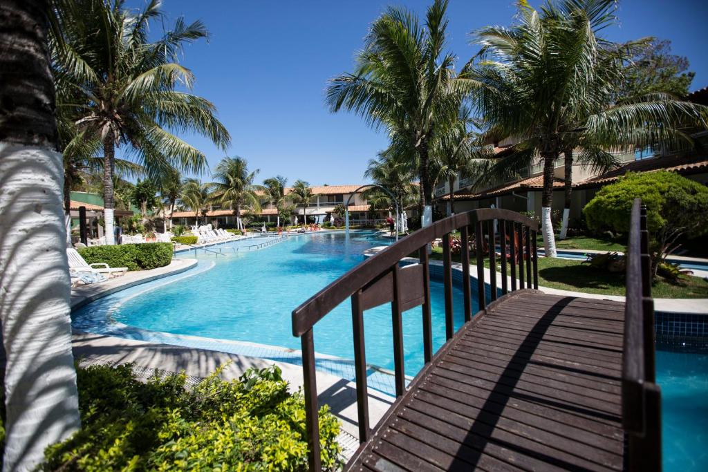a view of a swimming pool with palm trees at Hotel Atlântico Búzios Convention in Búzios