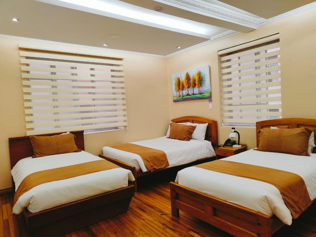 Postel nebo postele na pokoji v ubytování Hotel Carolina Montecarlo
