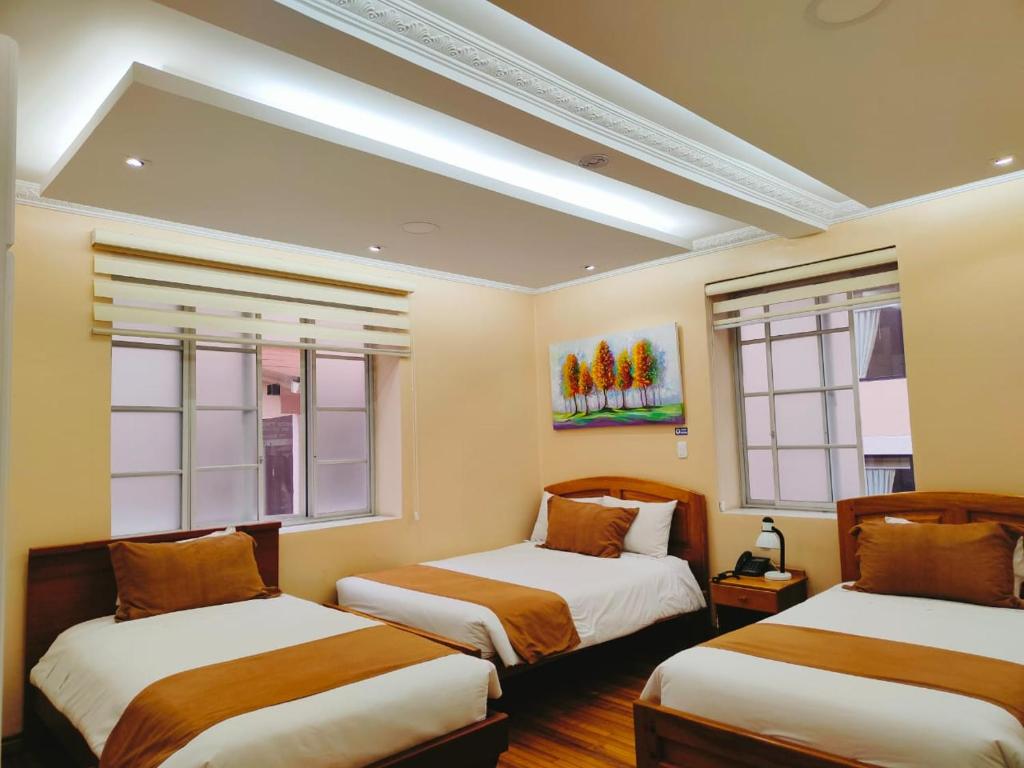 Postel nebo postele na pokoji v ubytování Hotel Carolina Montecarlo