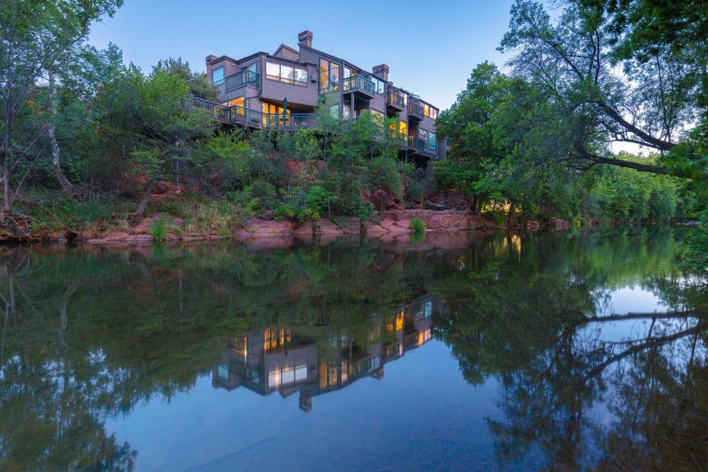 a large house sitting on the side of a river at Inn Above Oak Creek Sedona in Sedona